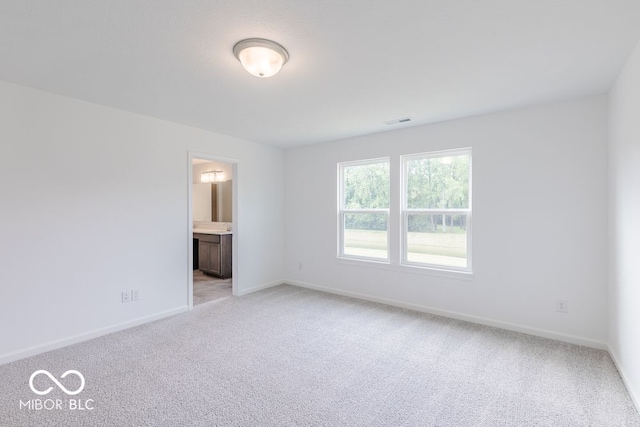 unfurnished room with light colored carpet