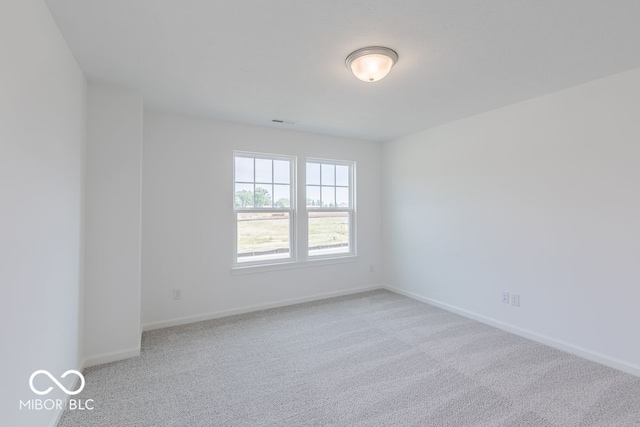 unfurnished room with light colored carpet