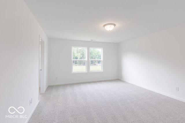 unfurnished room featuring light colored carpet