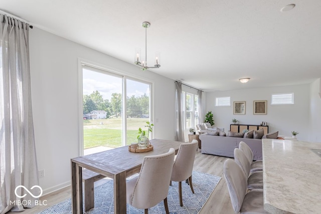 dining area featuring a chandelier and light hardwood / wood-style floors