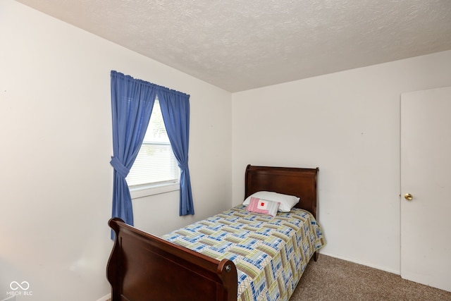 carpeted bedroom with a textured ceiling