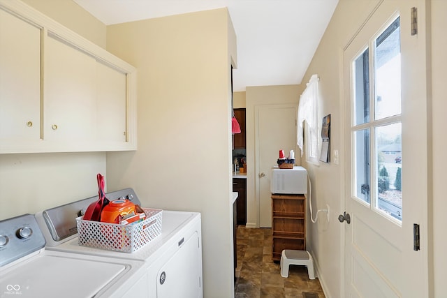 washroom with separate washer and dryer and cabinets