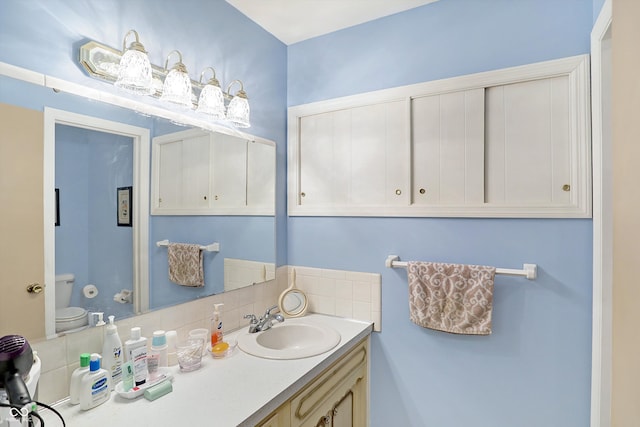 bathroom featuring vanity and toilet