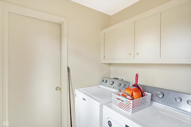 washroom featuring independent washer and dryer and cabinets