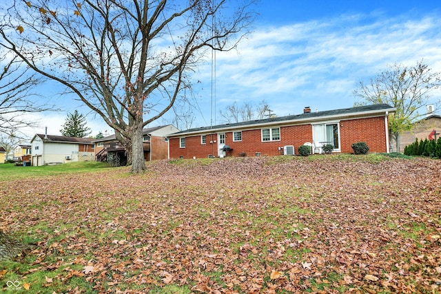 rear view of house featuring central air condition unit