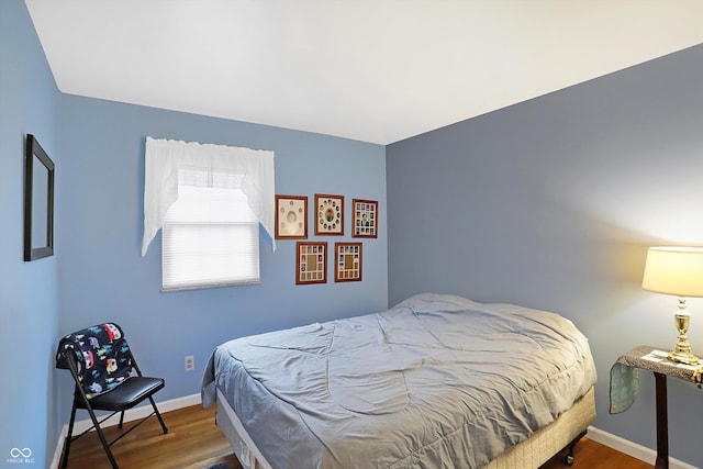 bedroom with hardwood / wood-style floors