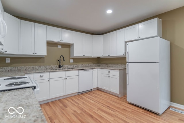 kitchen with white cabinetry, light wood-type flooring, white appliances, and sink