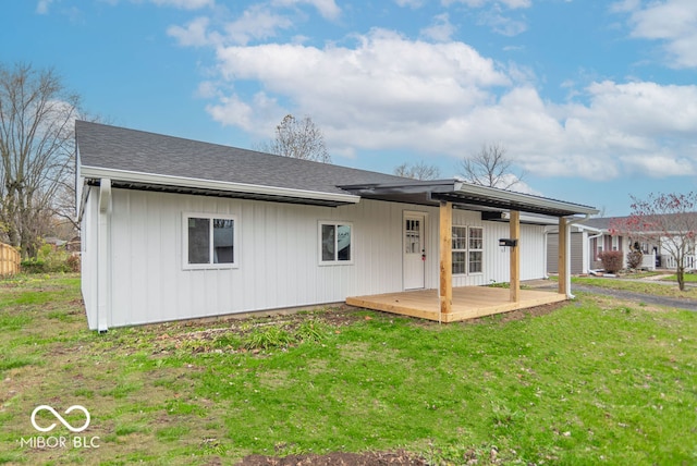 back of house with a yard and a deck