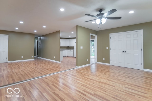 interior space with ceiling fan and light hardwood / wood-style floors