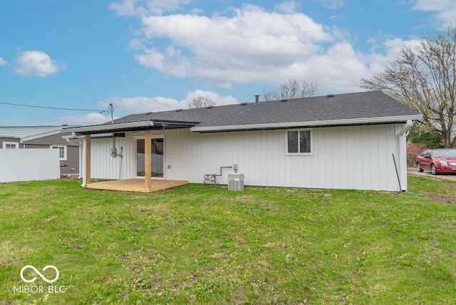 rear view of property with a yard and a deck