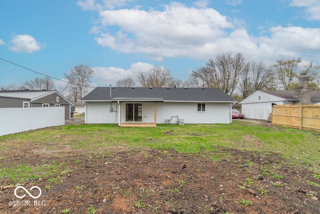 rear view of house featuring a yard