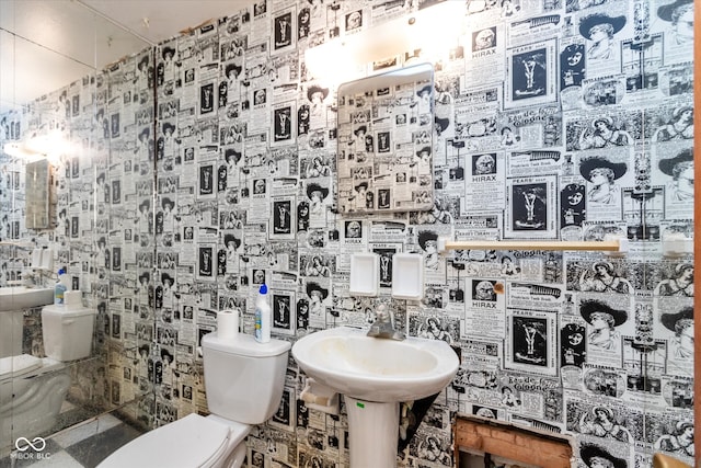 bathroom featuring toilet and tile walls