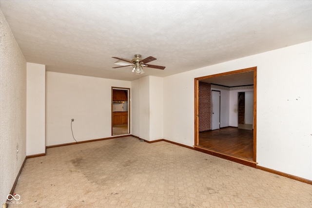 unfurnished room featuring ceiling fan, light hardwood / wood-style flooring, and a textured ceiling