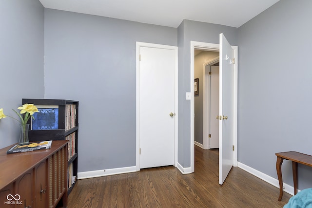 bedroom with dark hardwood / wood-style flooring