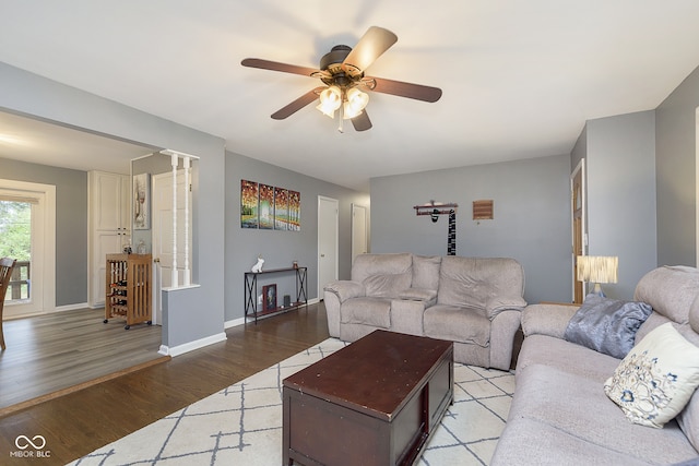 living room with ceiling fan and light hardwood / wood-style flooring