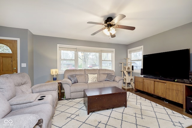 living room featuring light hardwood / wood-style floors and ceiling fan