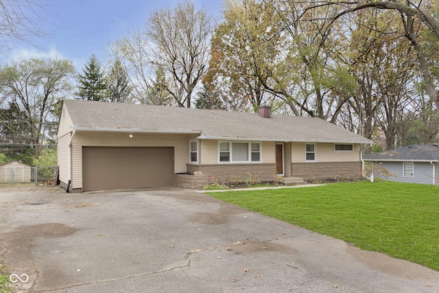 ranch-style home with a front yard and a garage