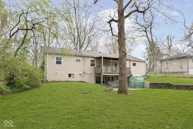 back of house featuring a yard and a deck