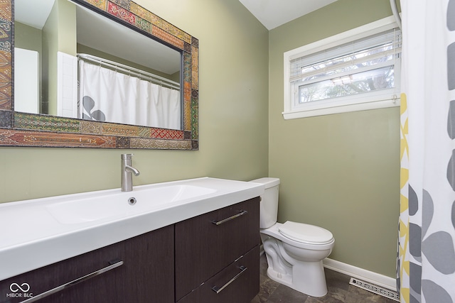 bathroom featuring vanity and toilet