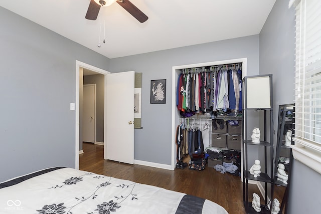 bedroom with ceiling fan, dark wood-type flooring, and a closet