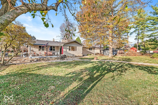 view of front of house featuring a front lawn and a patio area