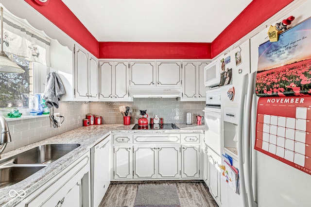 kitchen featuring hardwood / wood-style floors, white appliances, white cabinetry, and sink