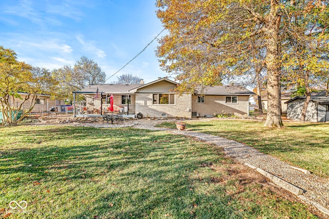 rear view of house with a patio and a lawn