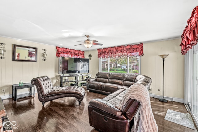 living room featuring ceiling fan and dark wood-type flooring