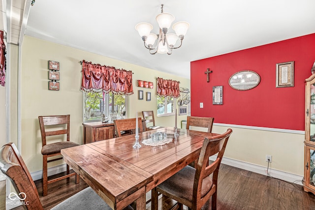 dining area featuring dark hardwood / wood-style floors and an inviting chandelier