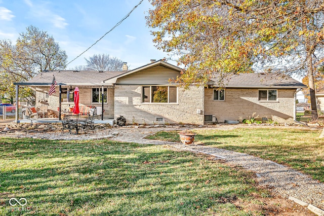 view of front of home featuring central air condition unit, a front yard, and a patio area