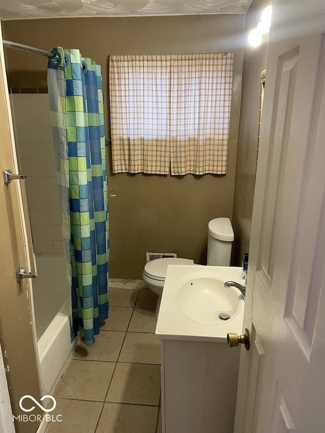 full bathroom featuring tile patterned floors, vanity, toilet, and shower / tub combo