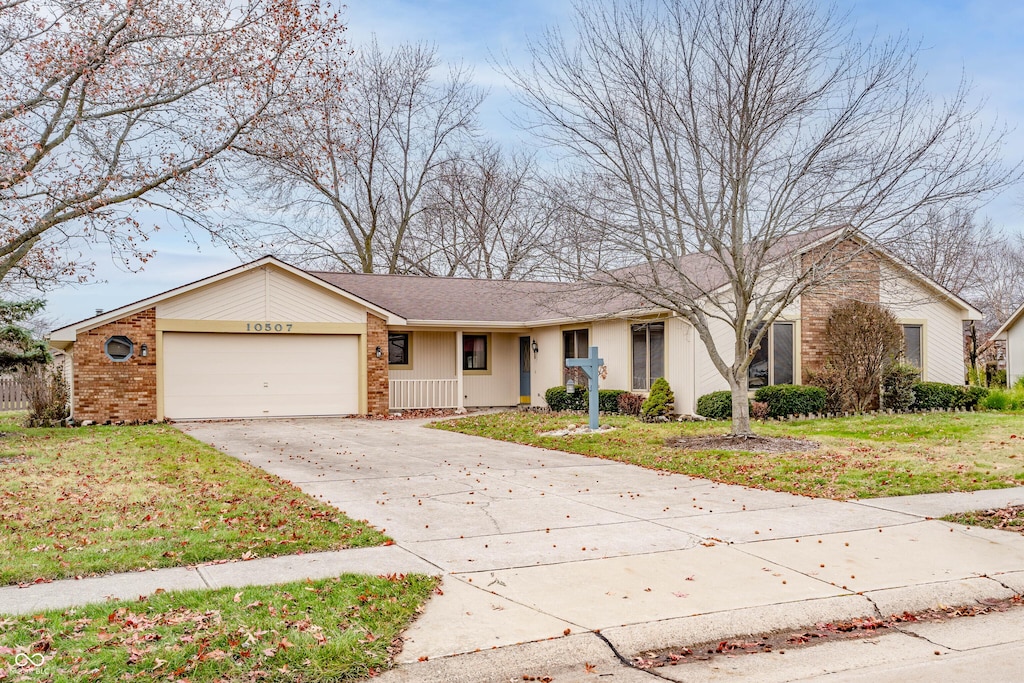 ranch-style home with a front yard and a garage