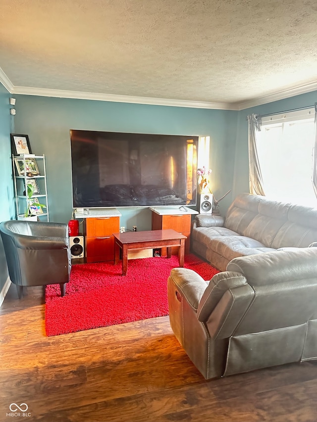 living room featuring hardwood / wood-style floors, a textured ceiling, and crown molding