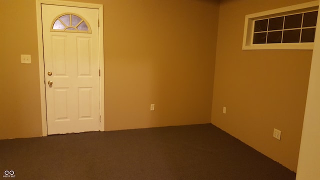 foyer entrance featuring carpet floors