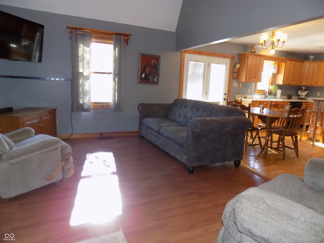 living room featuring hardwood / wood-style floors, a chandelier, and lofted ceiling