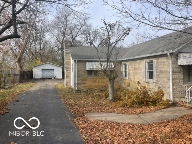 view of home's exterior featuring a garage and an outdoor structure