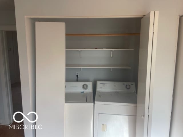 clothes washing area with separate washer and dryer