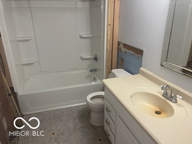 full bathroom with shower / washtub combination, vanity, tile patterned floors, and toilet