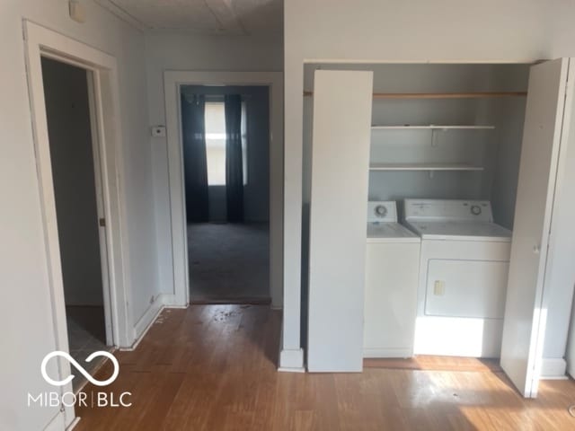 laundry area featuring hardwood / wood-style floors and washer and clothes dryer