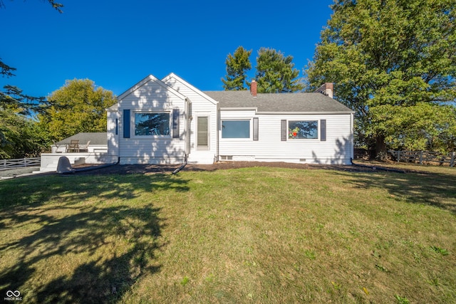 single story home featuring fence, a chimney, and a front lawn