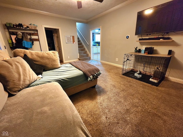 carpeted bedroom with ceiling fan, a textured ceiling, and ornamental molding