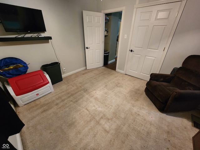 sitting room featuring light colored carpet