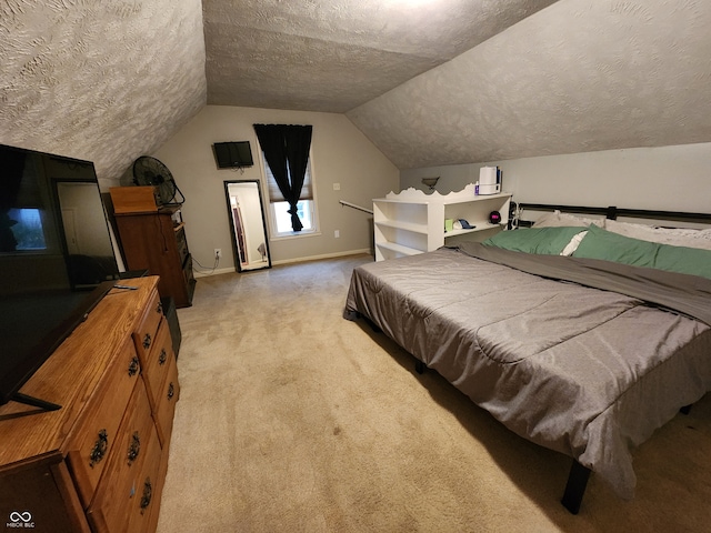 carpeted bedroom featuring a textured ceiling and lofted ceiling