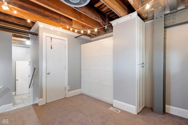 basement featuring light colored carpet