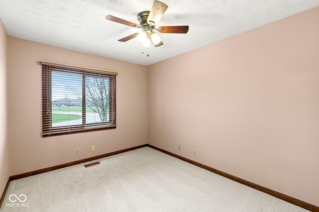 unfurnished room with light carpet, a textured ceiling, and ceiling fan