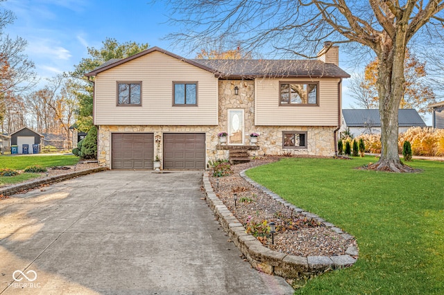 raised ranch with a front yard and a garage