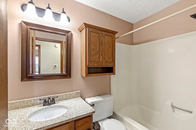 full bathroom with shower / tub combination, vanity, a textured ceiling, and toilet