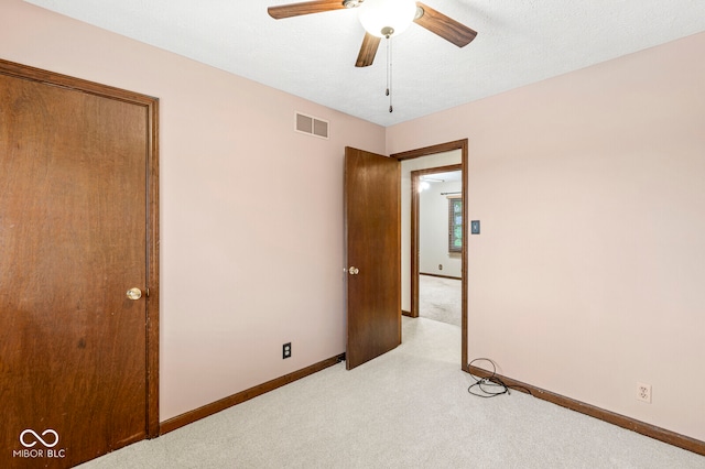 unfurnished bedroom featuring a textured ceiling and ceiling fan