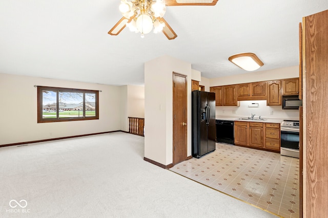 kitchen featuring ceiling fan, sink, light colored carpet, and black appliances