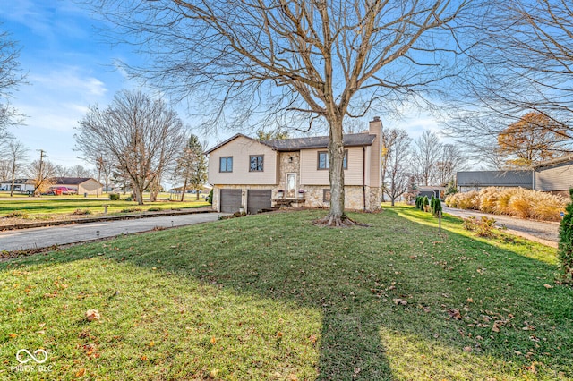 view of front of house featuring a garage and a front lawn